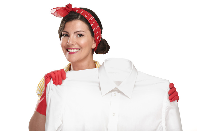 beautiful woman housewife showing a dirty shirt  on white