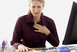 getty_rf_photo_of_woman_with_heartburn_at_work-1